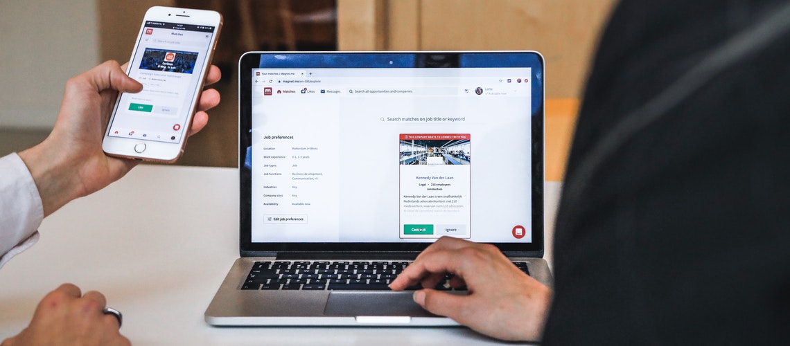 looking at a website through phone and laptop