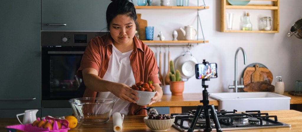 woman making a youtube video in the kitchen